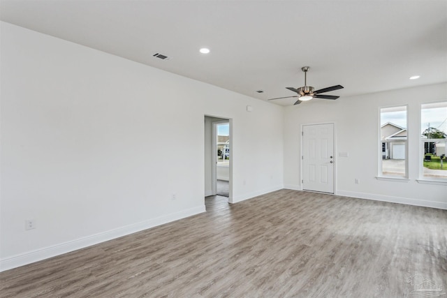 empty room with hardwood / wood-style flooring and ceiling fan