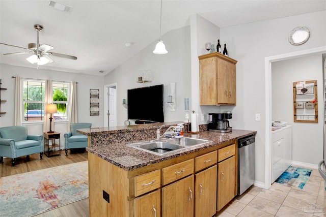 kitchen with dishwasher, kitchen peninsula, sink, and washing machine and clothes dryer