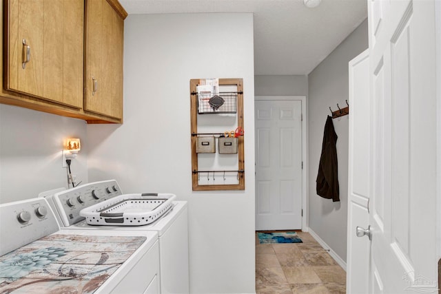 washroom with cabinets, a textured ceiling, and separate washer and dryer