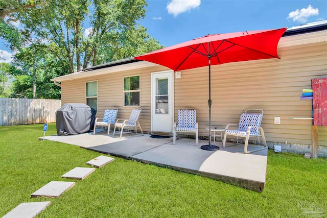 rear view of house featuring a patio and a yard