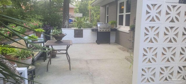 view of patio / terrace featuring area for grilling and a grill