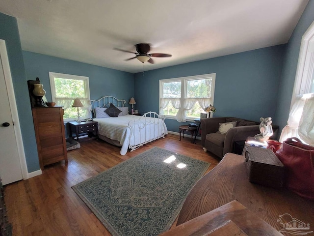 bedroom with ceiling fan and dark hardwood / wood-style floors