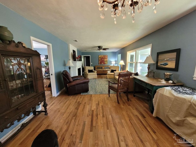 living room featuring light wood-type flooring and ceiling fan