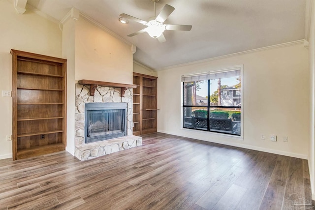 unfurnished living room featuring a stone fireplace, wood-type flooring, lofted ceiling, ornamental molding, and ceiling fan