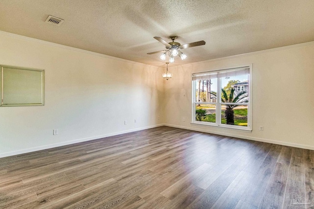 empty room featuring hardwood / wood-style floors, ornamental molding, a textured ceiling, and ceiling fan