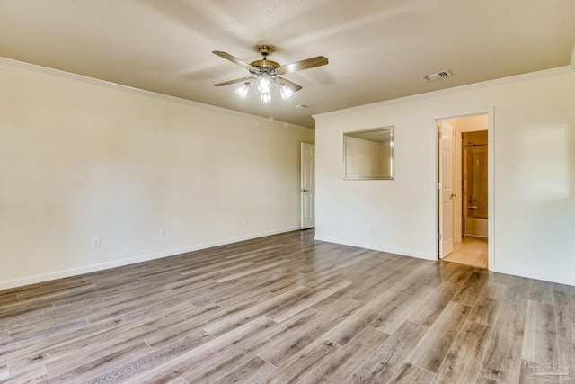 spare room featuring crown molding, ceiling fan, and light wood-type flooring