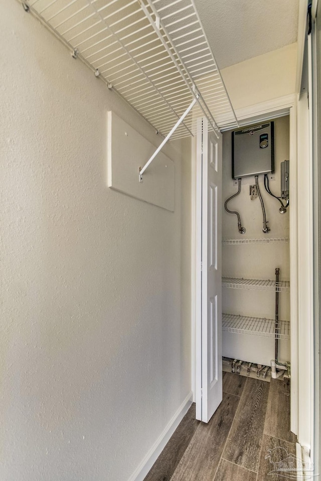 spacious closet featuring dark wood-type flooring