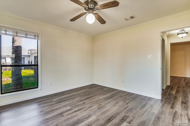 empty room featuring ornamental molding, hardwood / wood-style floors, and ceiling fan