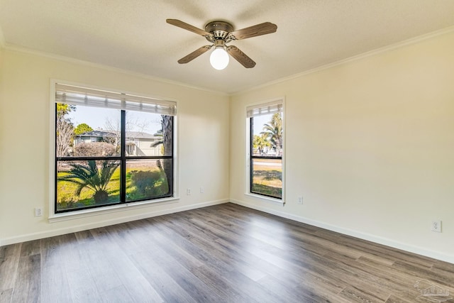 unfurnished room featuring crown molding, plenty of natural light, and hardwood / wood-style floors