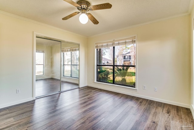 spare room featuring crown molding, ceiling fan, and dark hardwood / wood-style floors