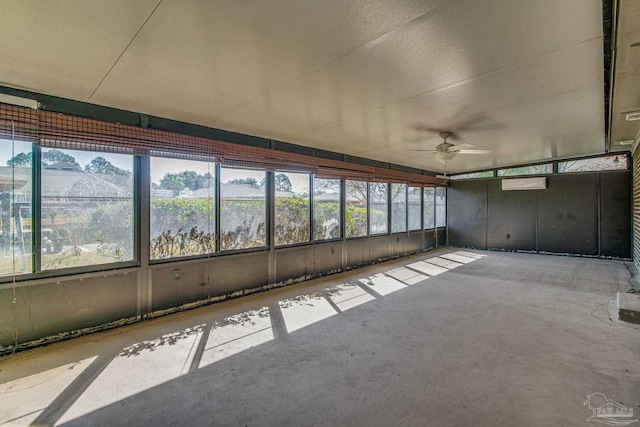 unfurnished sunroom featuring ceiling fan