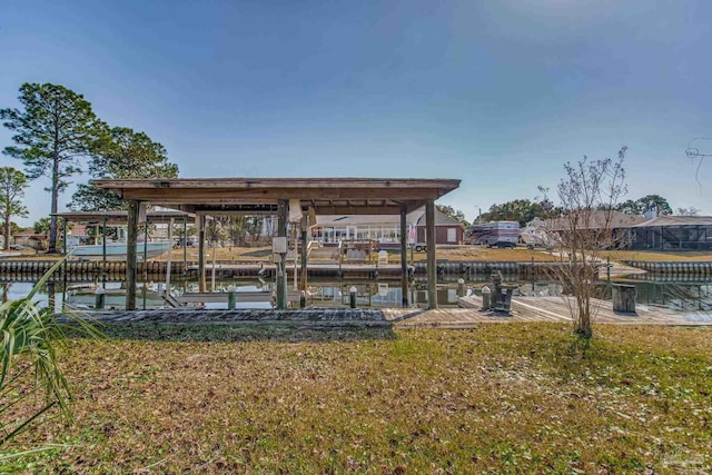 dock area with a yard and a water view