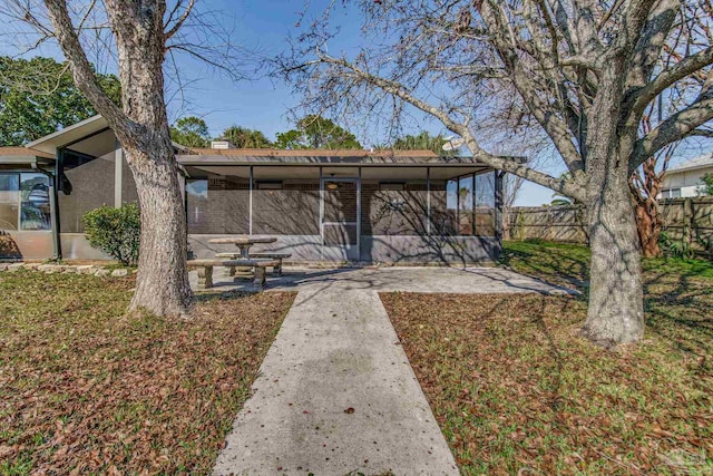 exterior space with a patio area and a sunroom