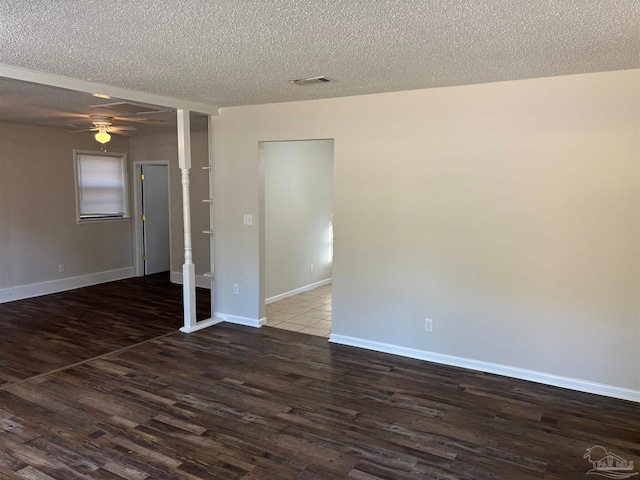 spare room featuring ceiling fan, a textured ceiling, and dark hardwood / wood-style flooring