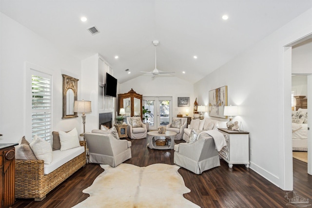 living room with dark wood-type flooring, vaulted ceiling, a wealth of natural light, and ceiling fan