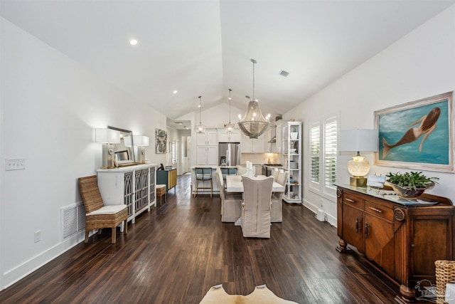 dining space featuring an inviting chandelier, lofted ceiling, and dark wood-type flooring