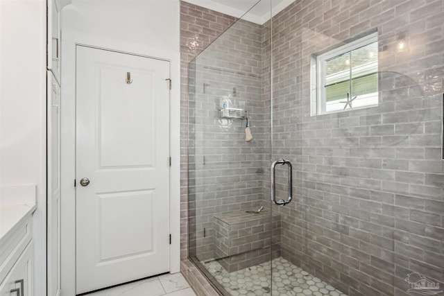 bathroom with vanity and a shower with shower door