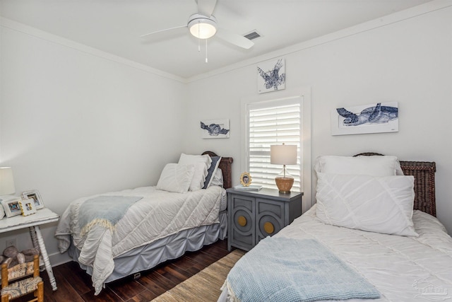 bedroom featuring dark wood-type flooring, ceiling fan, and crown molding