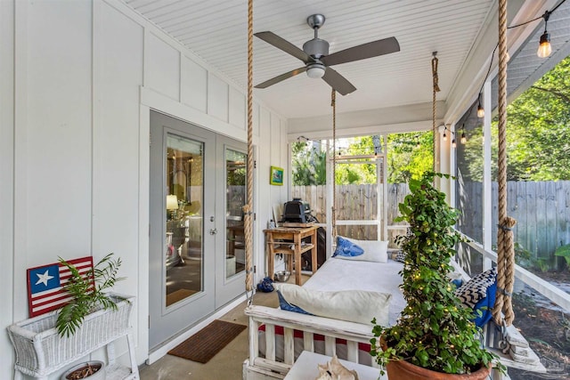 sunroom / solarium featuring french doors and ceiling fan