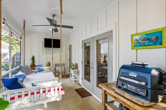 sunroom / solarium featuring french doors and ceiling fan