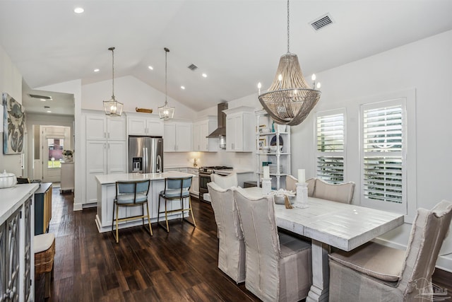 dining area with a notable chandelier, dark hardwood / wood-style floors, and high vaulted ceiling