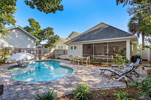 view of pool featuring a patio and a sunroom