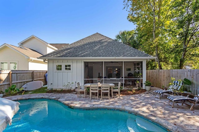 view of swimming pool with a patio and a sunroom