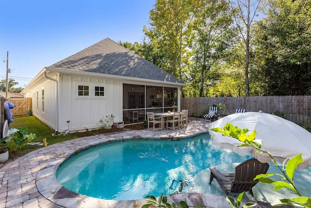 view of pool featuring a patio and a sunroom