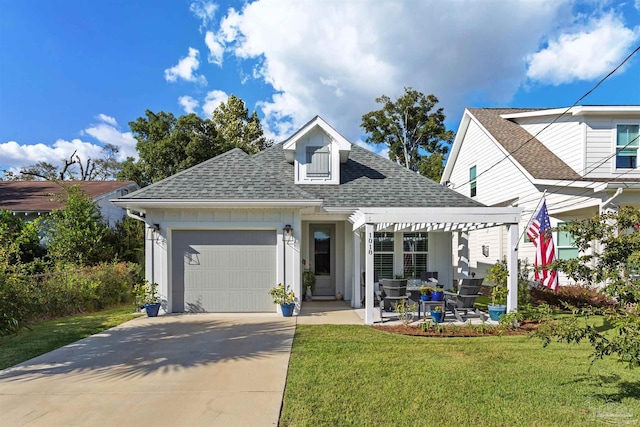 view of front of home with a front yard and a garage