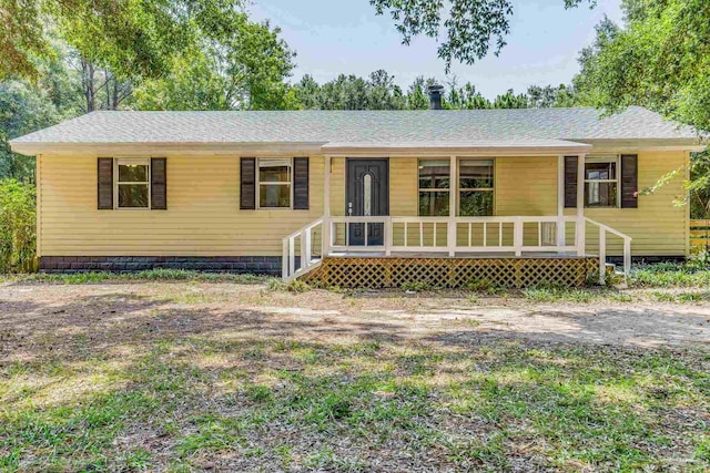 view of front of property with a porch and roof with shingles