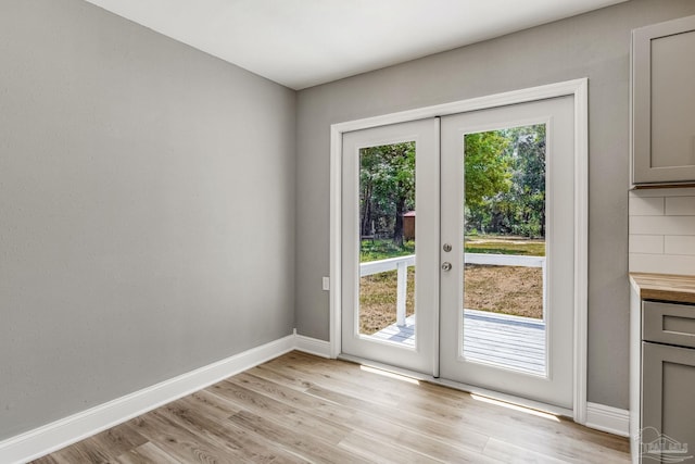 doorway to outside with light hardwood / wood-style floors, french doors, and a healthy amount of sunlight