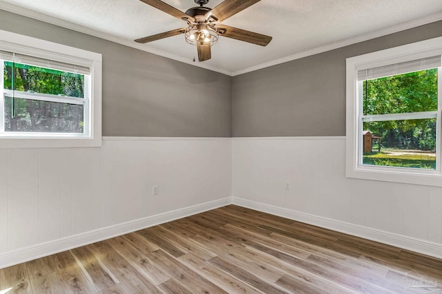 empty room featuring plenty of natural light and hardwood / wood-style floors