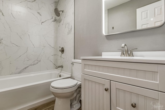 full bathroom with tiled shower / bath combo, wood-type flooring, toilet, and vanity