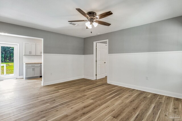 unfurnished room featuring ceiling fan and light hardwood / wood-style flooring