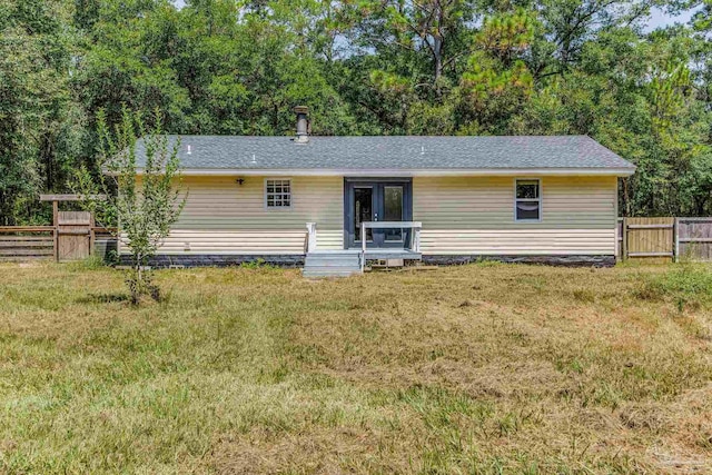 back of house featuring a yard