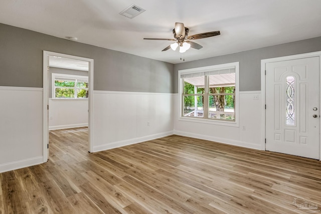 foyer with ceiling fan, light wood-type flooring, and a healthy amount of sunlight