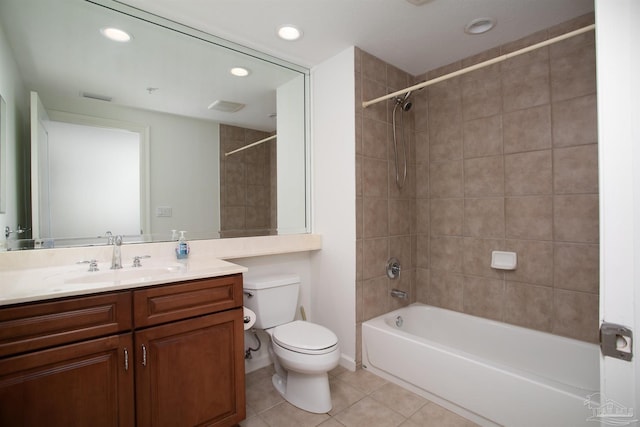 full bathroom with tile patterned floors, toilet, tiled shower / bath combo, and vanity