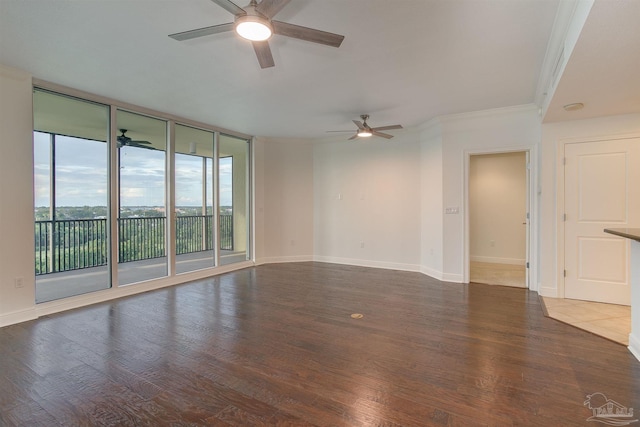 empty room with expansive windows, ceiling fan, ornamental molding, and dark hardwood / wood-style floors