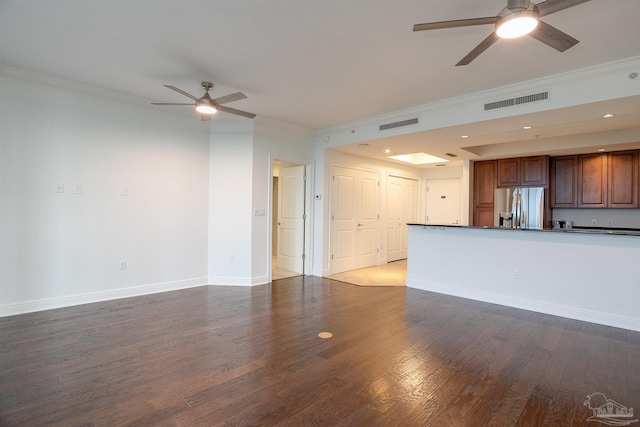 unfurnished living room with ornamental molding, ceiling fan, and dark hardwood / wood-style flooring