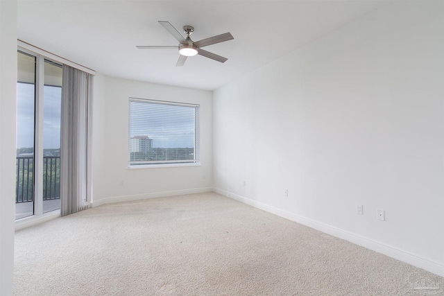 empty room with light colored carpet and ceiling fan