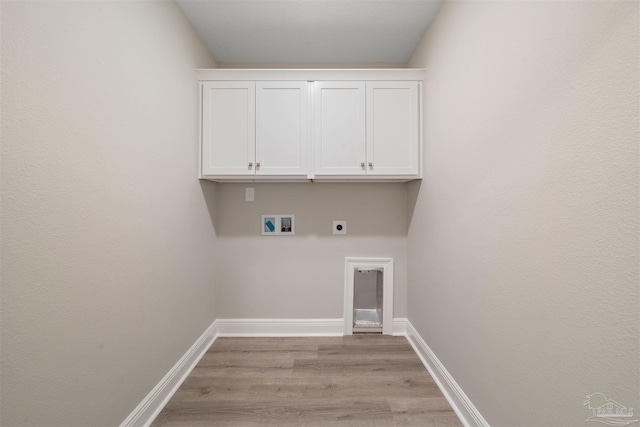 washroom featuring cabinets, washer hookup, electric dryer hookup, and light hardwood / wood-style flooring