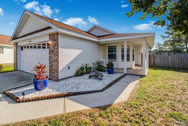 ranch-style house with a porch, a garage, and a front yard