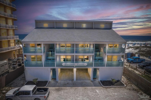 14259 Perdido Key Dr Unit 1C, Pensacola, FL 32507 - back of house featuring a shingled roof, gravel driveway, and a balcony