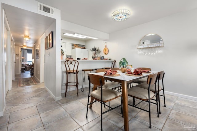 14259 Perdido Key Dr Unit 1C, Pensacola, FL 32507 - dining area featuring light tile patterned flooring, visible vents, and baseboards