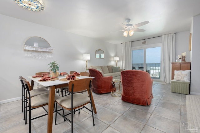 14259 Perdido Key Dr Unit 1C, Pensacola, FL 32507 - dining area featuring light tile patterned flooring, a ceiling fan, and baseboards