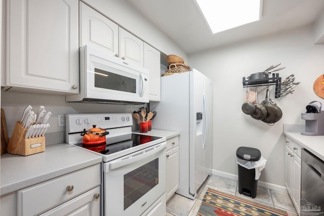 14259 Perdido Key Dr Unit 1C, Pensacola, FL 32507 - kitchen with white cabinetry, white appliances, light tile patterned flooring, and light countertops