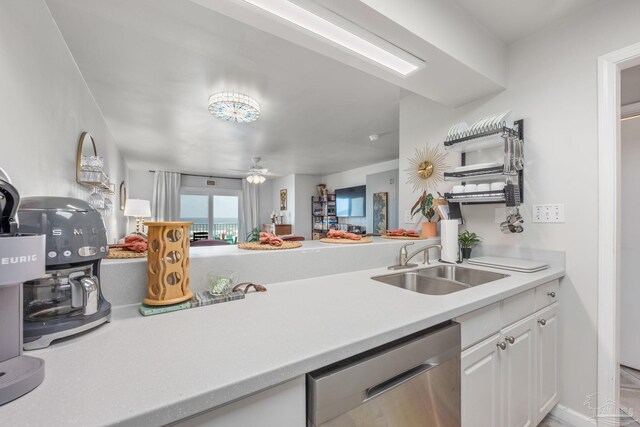 14259 Perdido Key Dr Unit 1C, Pensacola, FL 32507 - kitchen with a sink, ceiling fan, white cabinetry, light countertops, and dishwasher