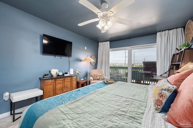 14259 Perdido Key Dr Unit 1C, Pensacola, FL 32507 - bedroom featuring baseboards, access to exterior, a ceiling fan, and wood finished floors