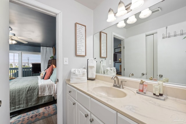 14259 Perdido Key Dr Unit 1C, Pensacola, FL 32507 - bathroom with wood finished floors, ensuite bathroom, vanity, visible vents, and a ceiling fan