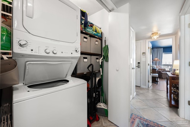 14259 Perdido Key Dr Unit 1C, Pensacola, FL 32507 - laundry area with stacked washer and dryer, light tile patterned floors, and laundry area